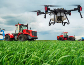 Modern technologies in agriculture. An industrial drone flies over a green field. tractors cultivate the soil in rural areas. The concept of technological agriculture