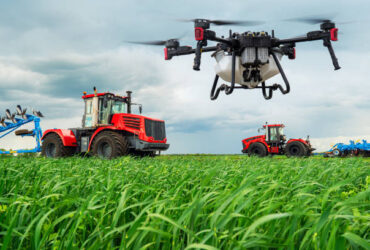 Modern technologies in agriculture. An industrial drone flies over a green field. tractors cultivate the soil in rural areas. The concept of technological agriculture